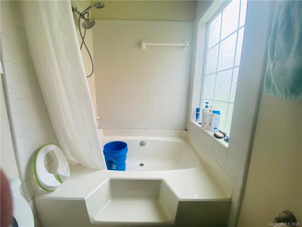 7121 Rena Mae Lane Charlotte, NC 28227 - Photo 10 of 21 a bathroom with a sink a window and tub