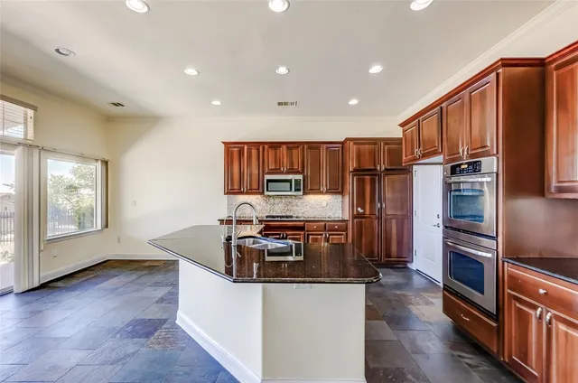 a kitchen with stainless steel appliances a stove and a refrigerator