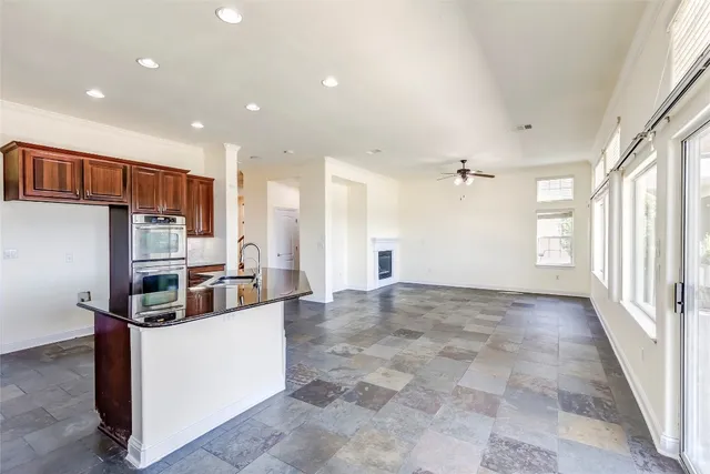 a kitchen that has a sink and a stove top oven