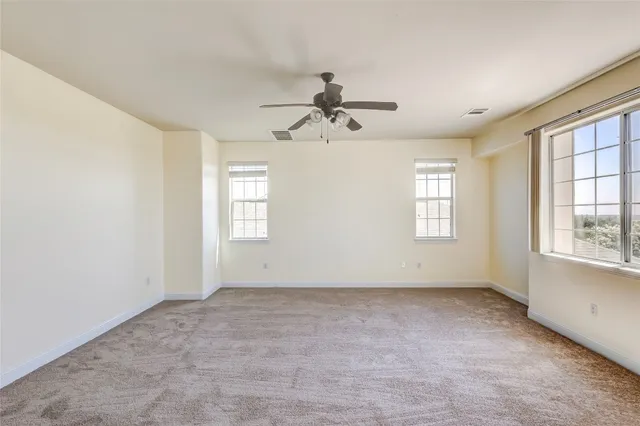 a view of a livingroom with a ceiling fan and window