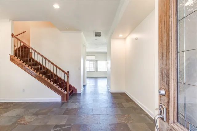 a view of entryway and hall with wooden floor