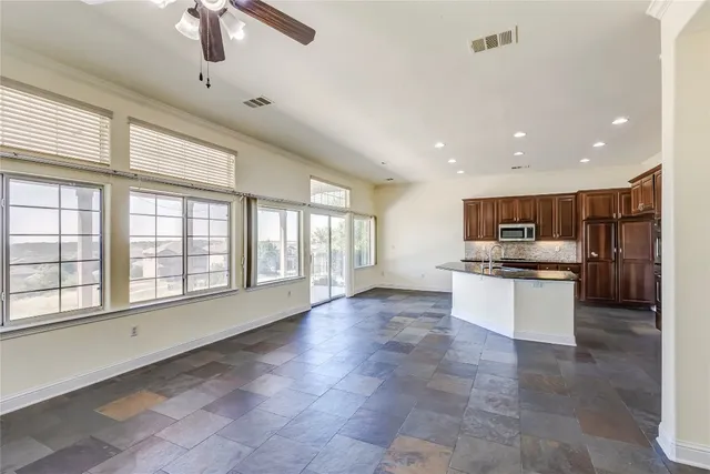 a room with kitchen view and a fireplace
