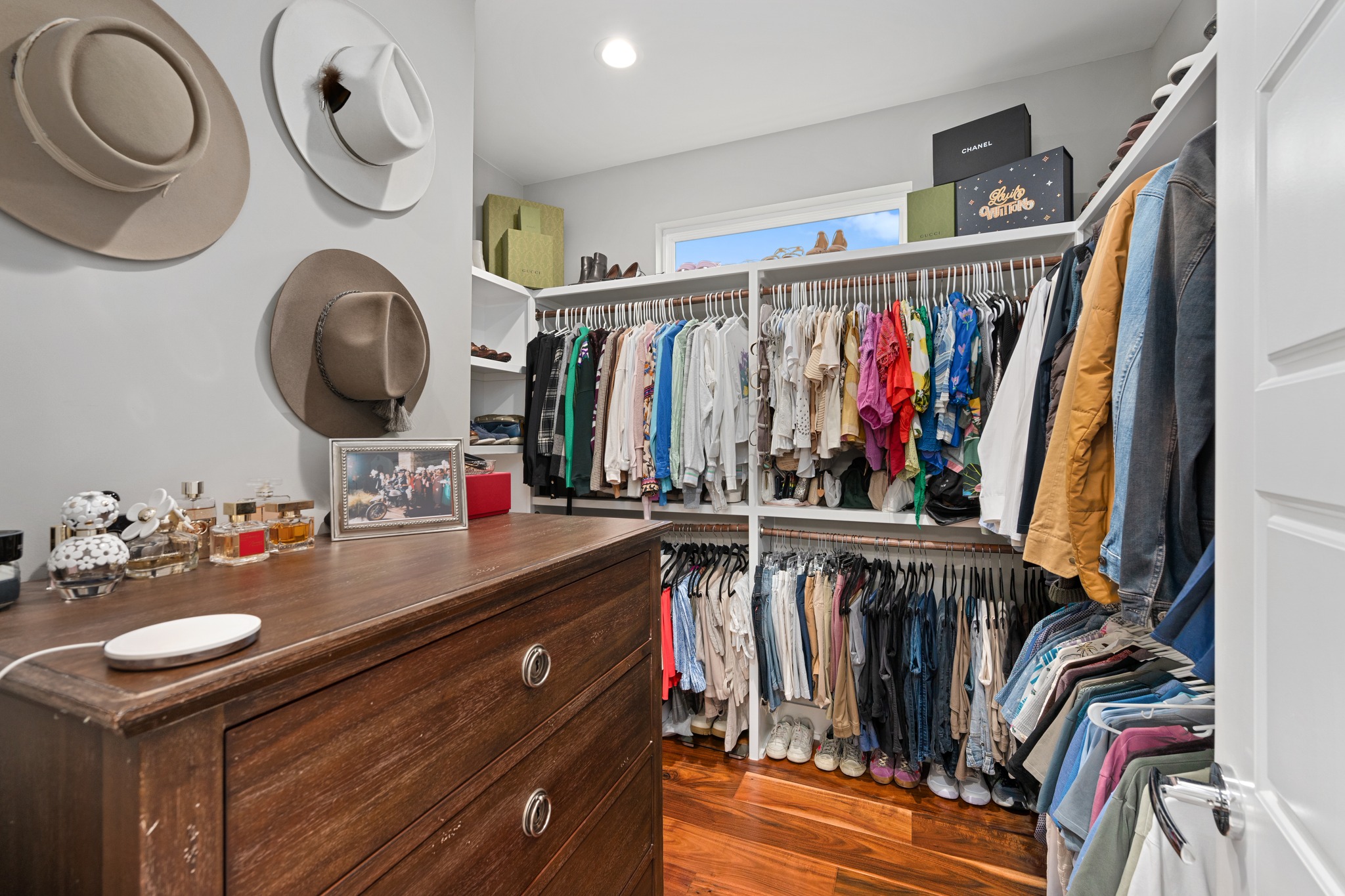 1103 Saucedo Street, Unit 1 Austin, TX 78721 - Photo 33 of 40 Ample shelving and hanging space in this well-organized walk-in closet with hardwood floors.