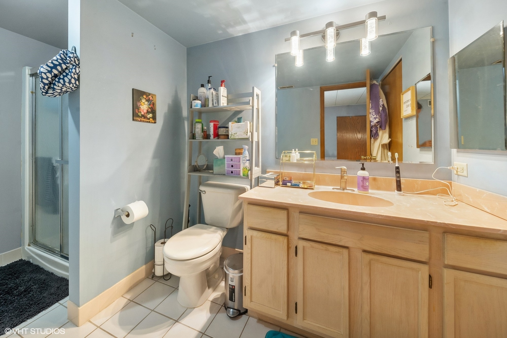 4232 West 77th Street, Unit 206 Chicago, IL 60652 - Photo 14 of 17 a bathroom with a sink a toilet and a mirror