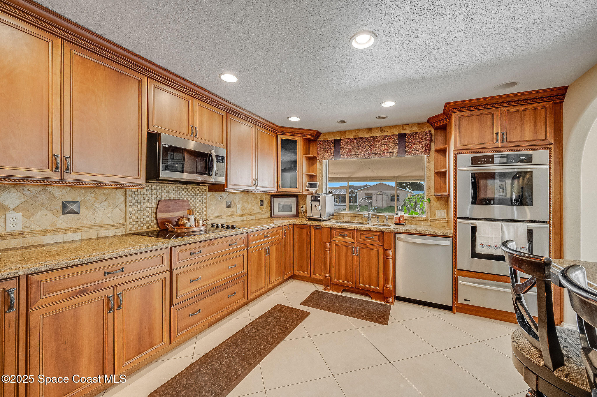 1480 West Riviera Drive Merritt Island, FL 32952 - Photo 11 of 93 a kitchen with stainless steel appliances granite countertop a refrigerator oven a sink dishwasher and white cabinets with wooden floor