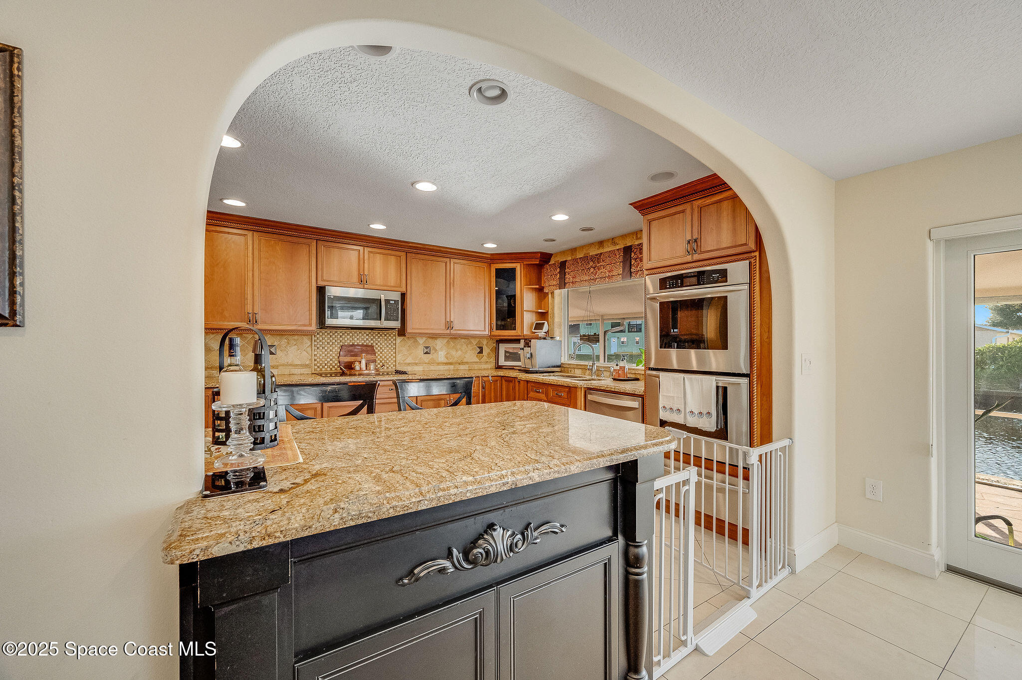 1480 West Riviera Drive Merritt Island, FL 32952 - Photo 14 of 93 a kitchen with stainless steel appliances granite countertop a sink a stove and a refrigerator