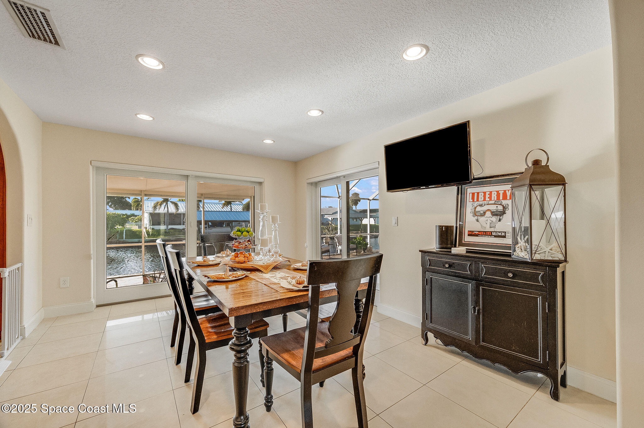 1480 West Riviera Drive Merritt Island, FL 32952 - Photo 21 of 93 a view of a dining room with furniture and a flat screen tv