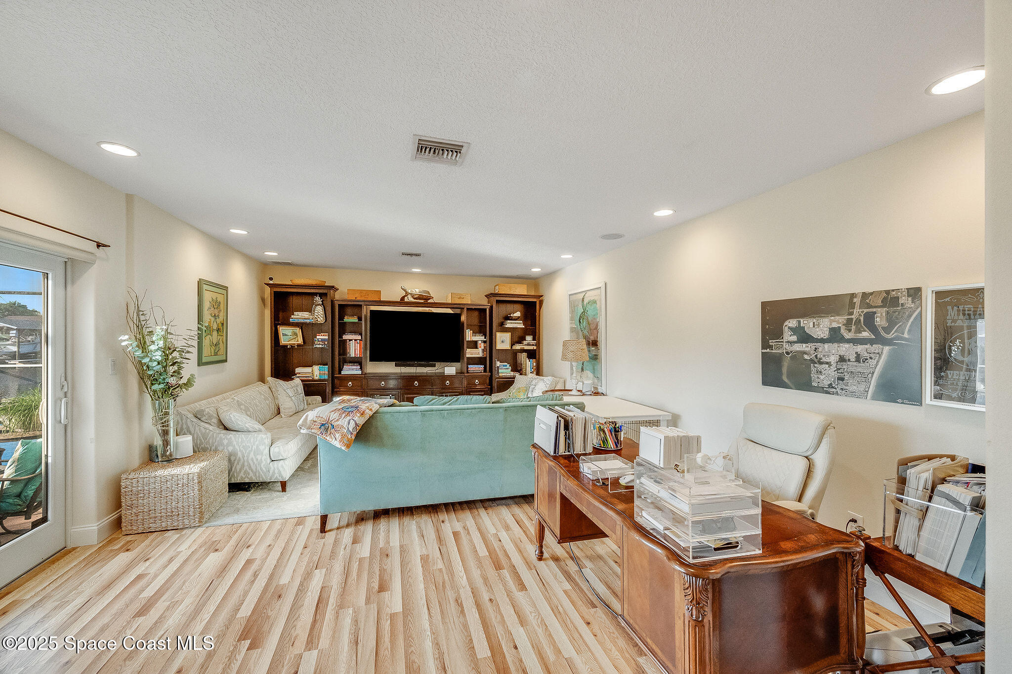 1480 West Riviera Drive Merritt Island, FL 32952 - Photo 28 of 93 a living room with furniture and a flat screen tv