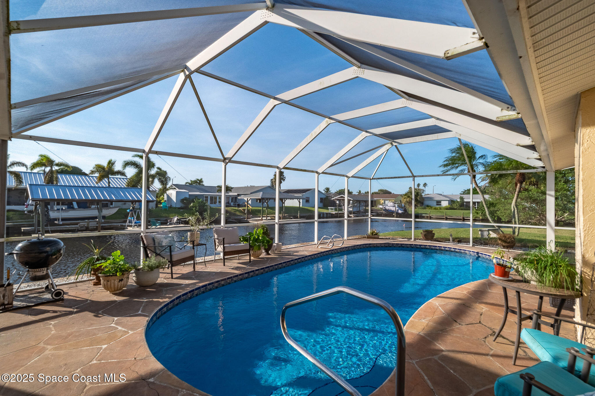 1480 West Riviera Drive Merritt Island, FL 32952 - Photo 3 of 93 a view of a swimming pool with a patio