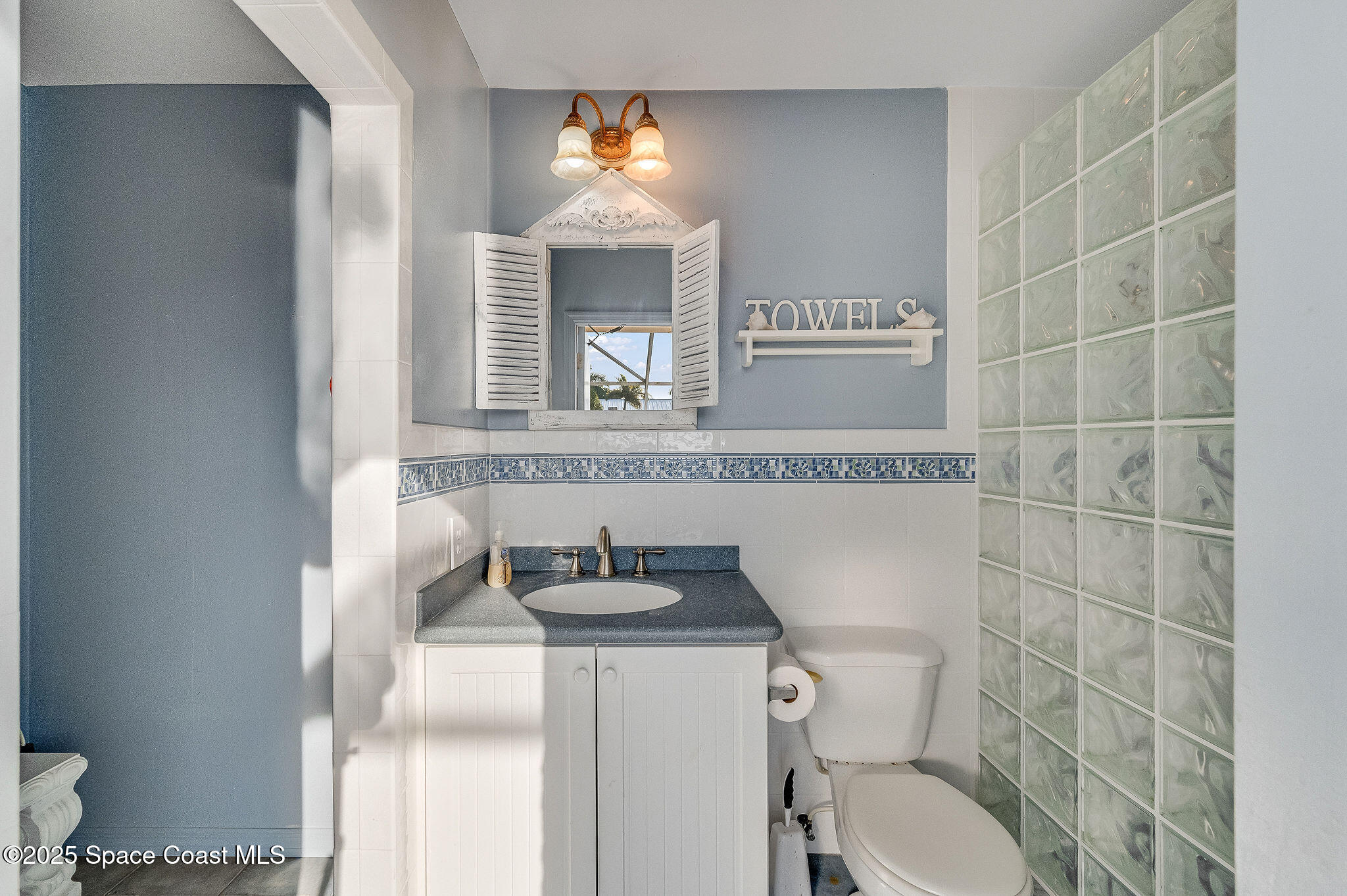 1480 West Riviera Drive Merritt Island, FL 32952 - Photo 51 of 93 a bathroom with a granite countertop toilet sink and mirror