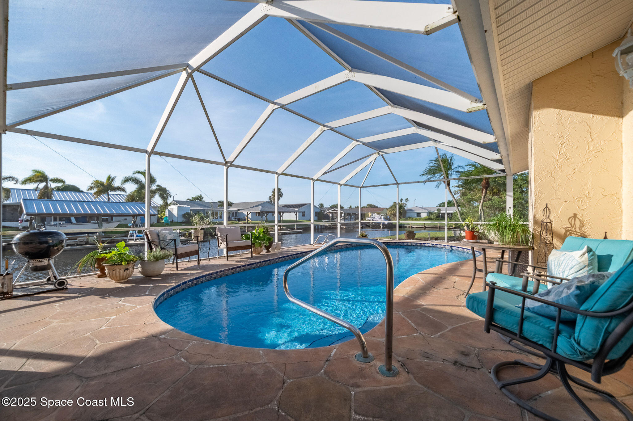 1480 West Riviera Drive Merritt Island, FL 32952 - Photo 53 of 93 a view of a swimming pool with couches chairs dining table and chairs