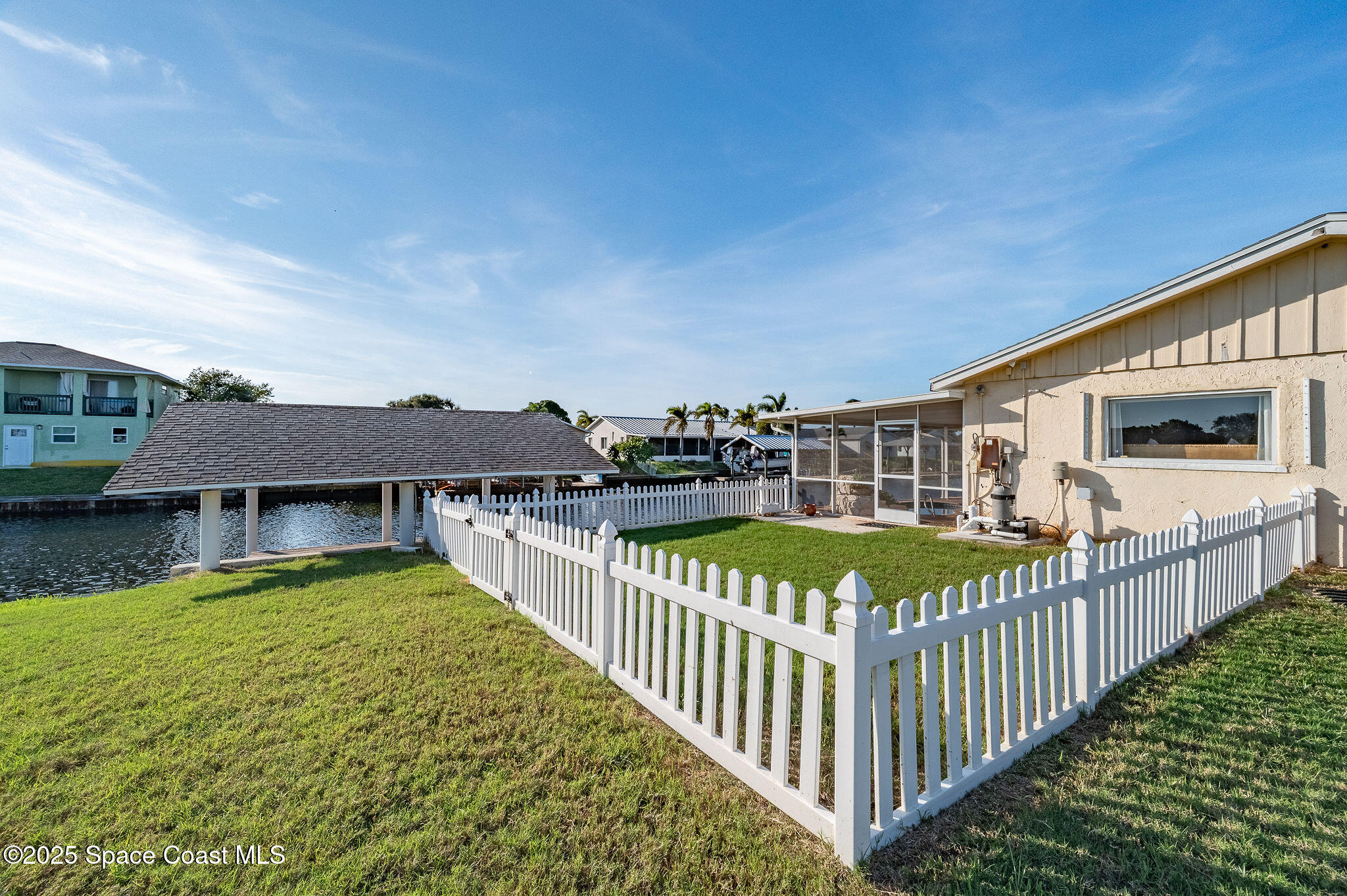 1480 West Riviera Drive Merritt Island, FL 32952 - Photo 71 of 93 a view of a house with wooden fence