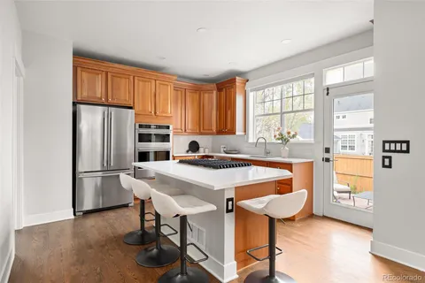 a kitchen with stainless steel appliances granite countertop a stove refrigerator and a refrigerator
