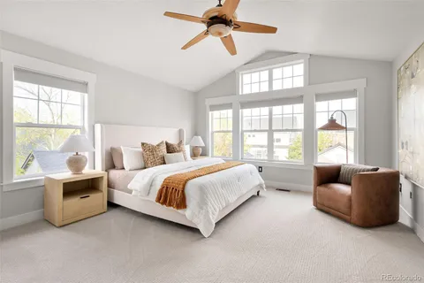 a spacious bedroom with a bed and a couch