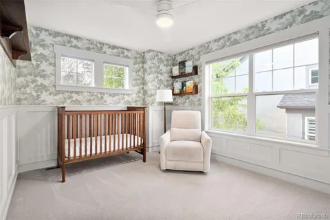 a spacious bedroom with a bed and a large window