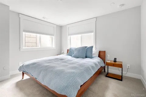 a spacious bedroom with a bed and a window