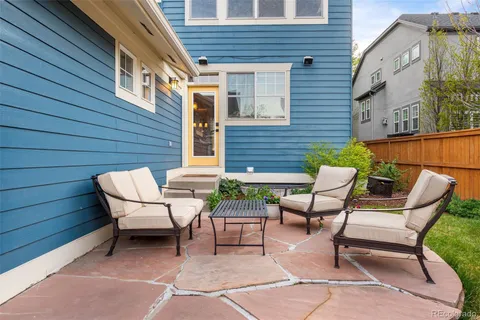 a view of a patio with couple of chairs and a table