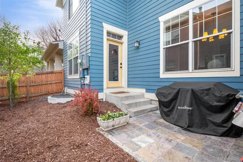 a wooden bench sitting in front of a house
