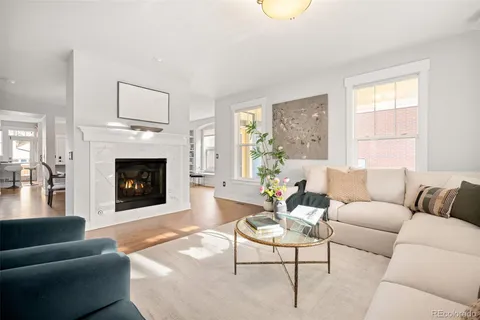 a living room with furniture a window and a fireplace