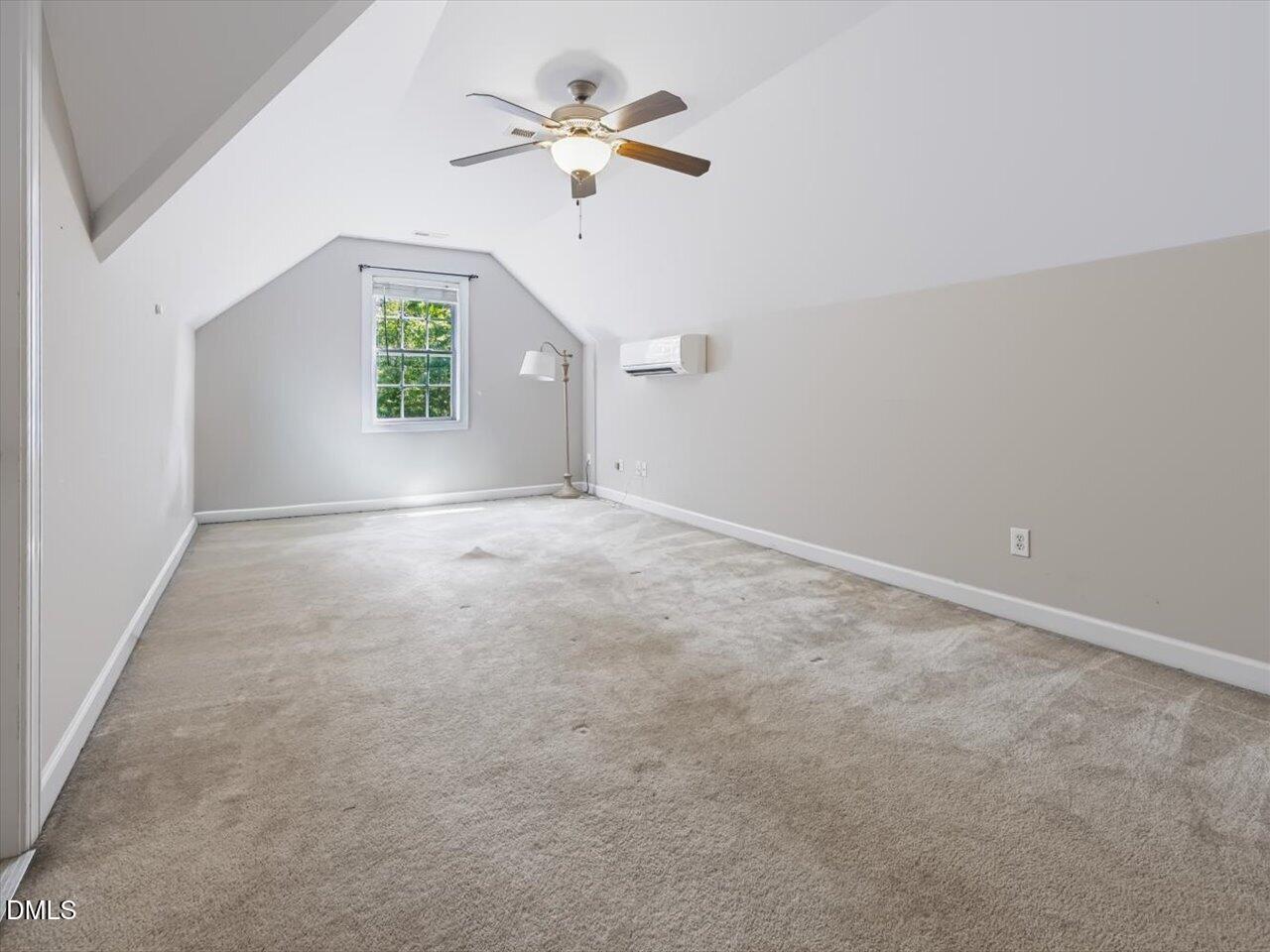 450 Ryan Road Pittsboro, NC 27312 - Photo 47 of 73 Bedroom 4 - Upstairs - Featuring Vaulted Ceiling, Ceiling Fan Fixture, Window with Matured Trees View, and Wall Mounted Climate Control Unit