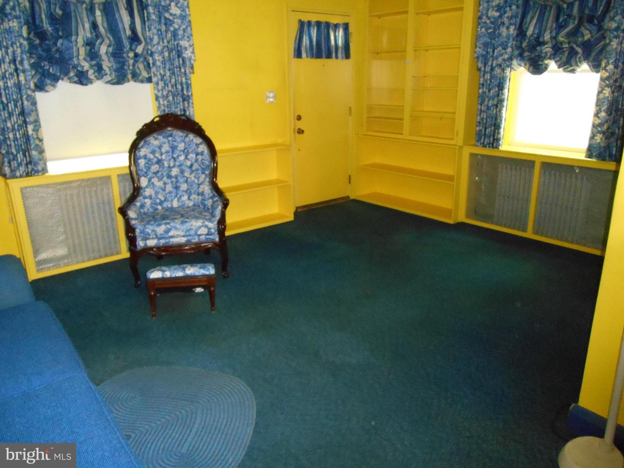 6403 Crestwood Road Baltimore, MD 21239 - Photo 4 of 15 a room with a chair and a table