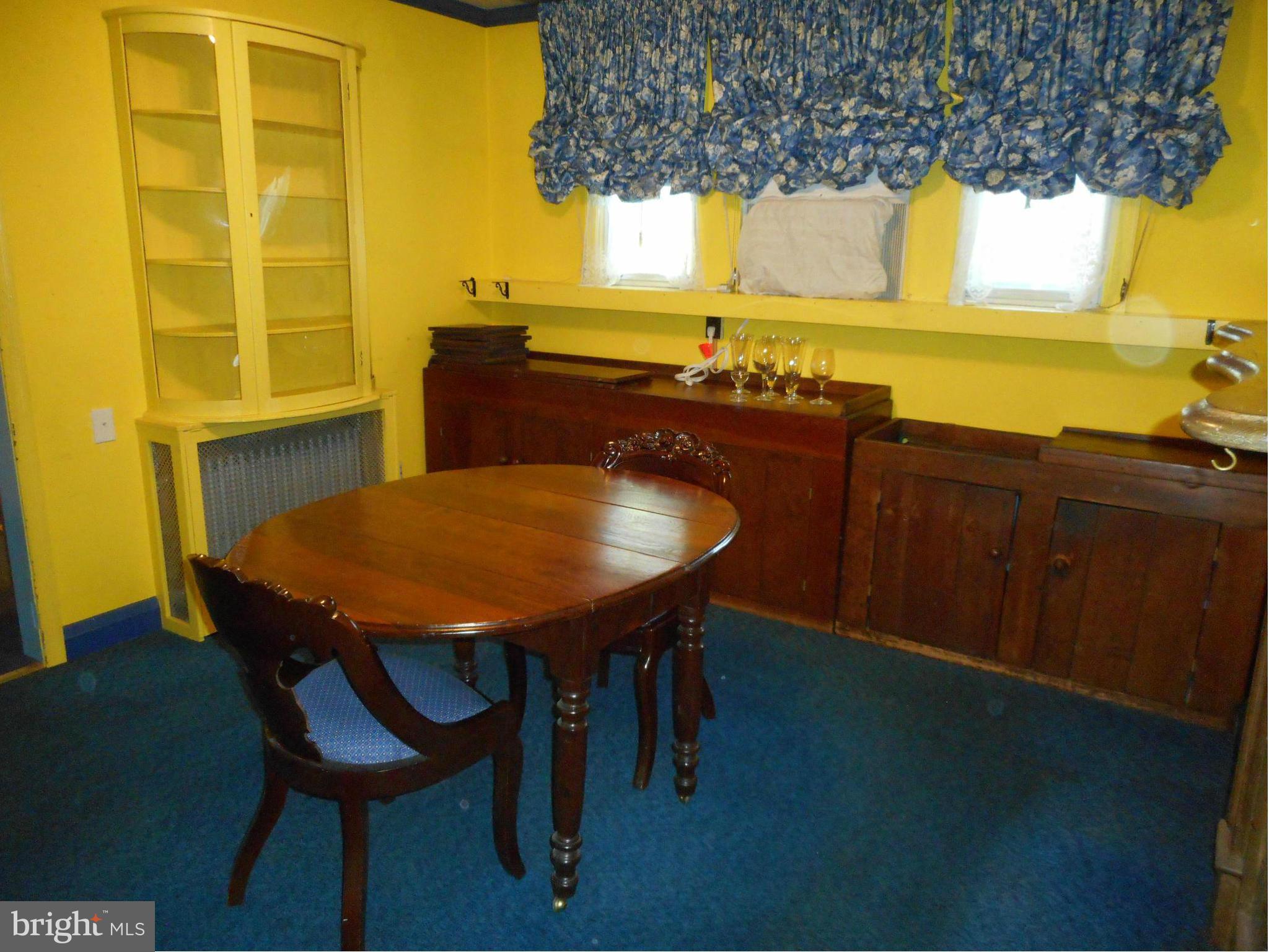 6403 Crestwood Road Baltimore, MD 21239 - Photo 5 of 15 a table with chairs in front of it