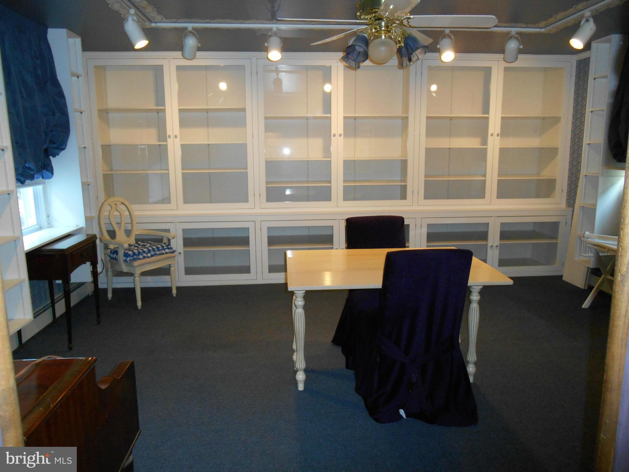 6403 Crestwood Road Baltimore, MD 21239 - Photo 6 of 15 a view of a workspace with furniture and a window