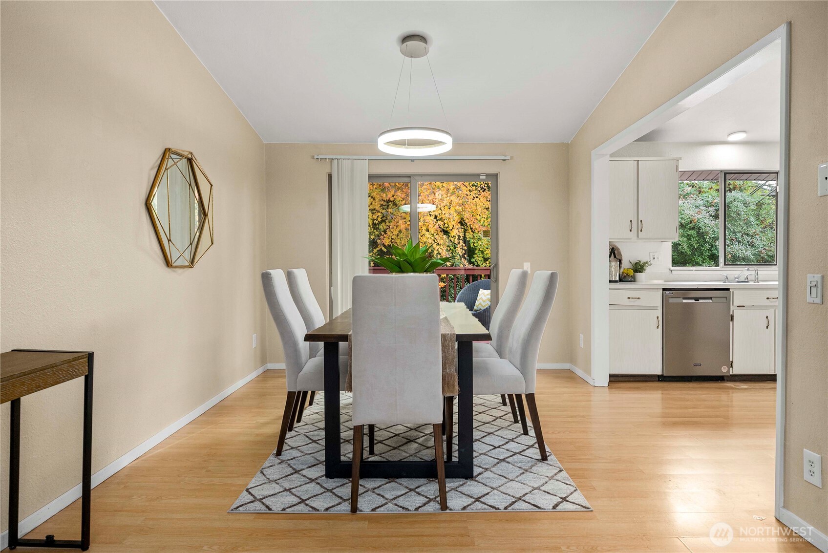 10316 Northeast 202nd Street Bothell, WA 98011 - Photo 10 of 40 a view of a dining room with furniture window and wooden floor