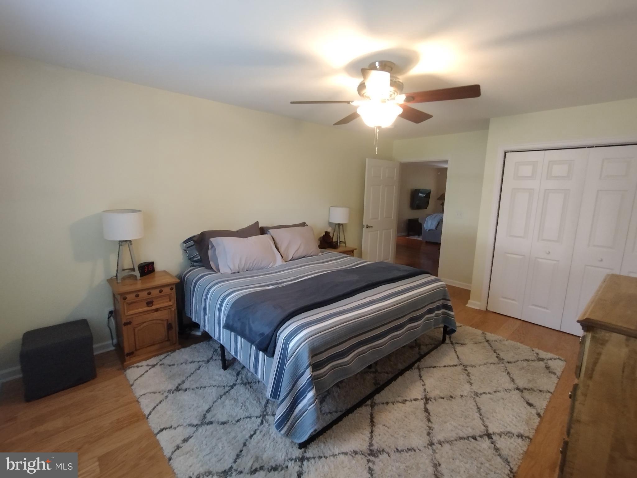 177 Raft Court Inwood, WV 25428 - Photo 25 of 40 a bedroom with a bed and a chandelier