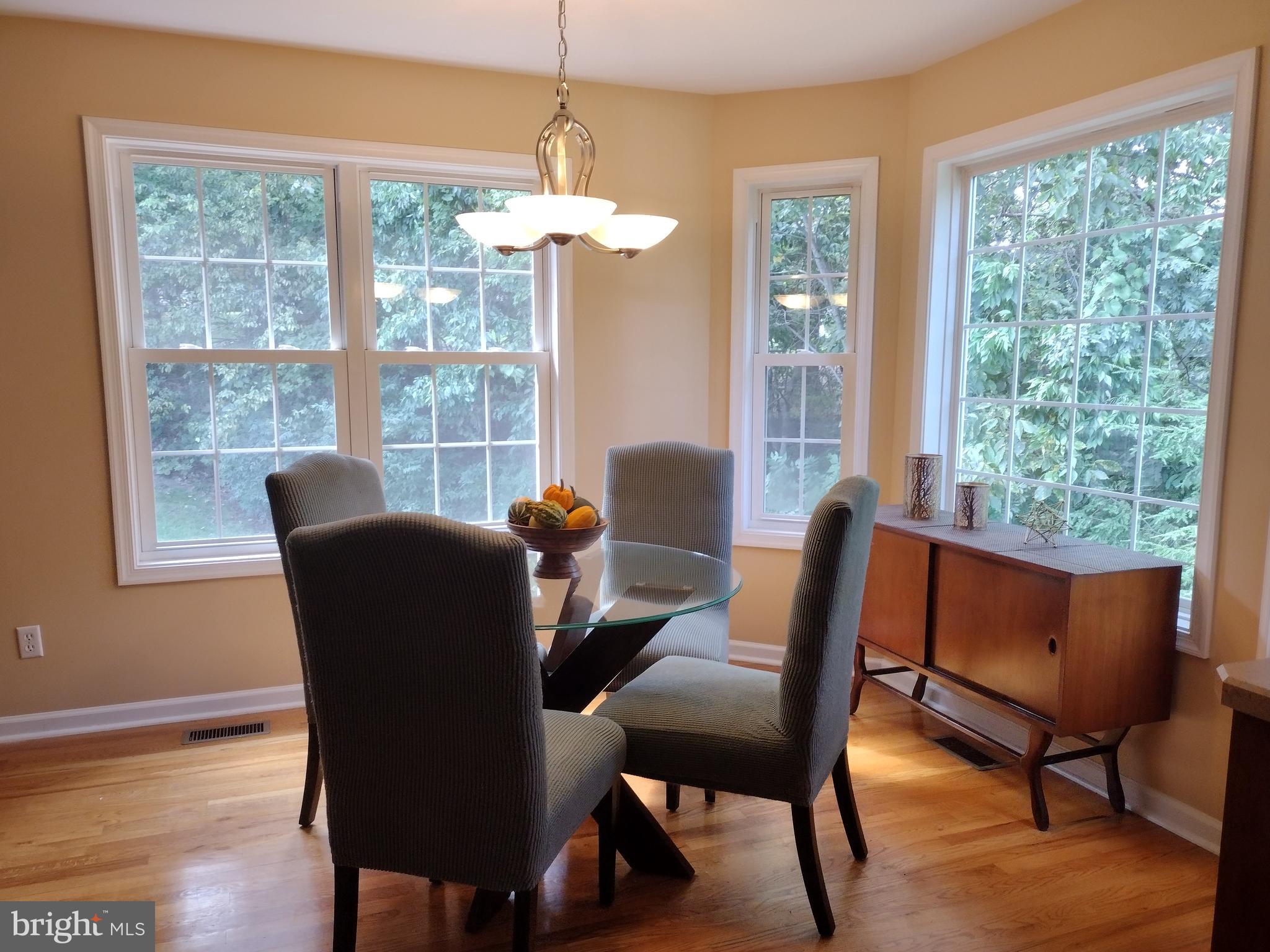 177 Raft Court Inwood, WV 25428 - Photo 10 of 40 a dining room with furniture a chandelier and wooden floor