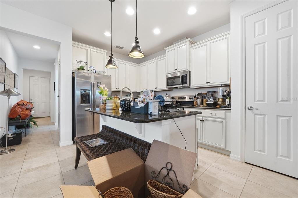 3461 Fallbrook Drive Kissimmee, FL 34759 - Photo 13 of 43 a kitchen with stainless steel appliances kitchen island granite countertop a sink and cabinets