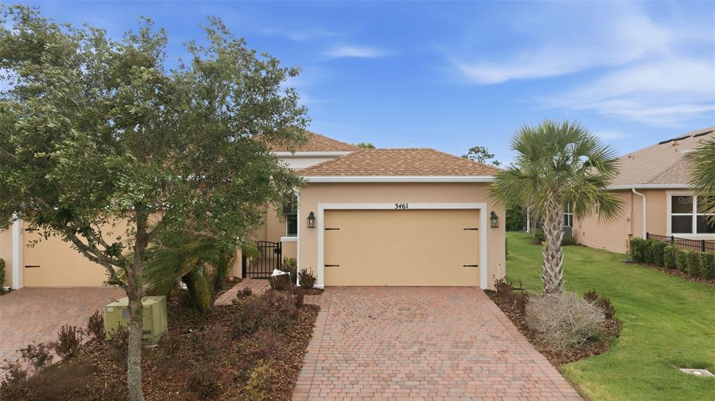 3461 Fallbrook Drive Kissimmee, FL 34759 - Photo 2 of 43 a front view of a house with a yard and garage