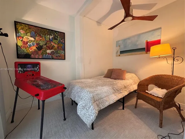 a bedroom with a bed a dresser and chair