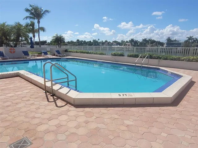 a view of swimming pool with outdoor seating and plants