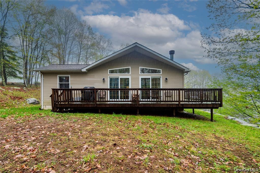 a view of a house with a yard and sitting area