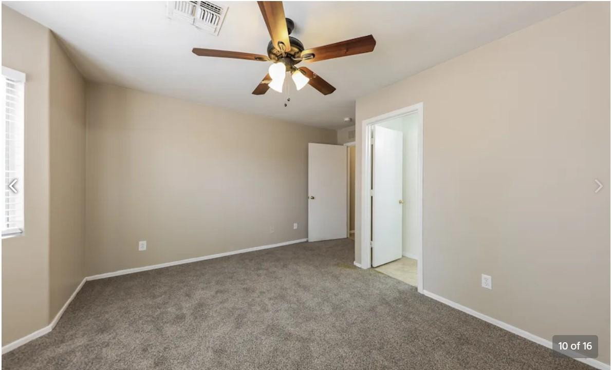 12563 West Charter Oak Road El Mirage, AZ 85335 - Photo 10 of 16 an empty room with a ceiling fan and window
