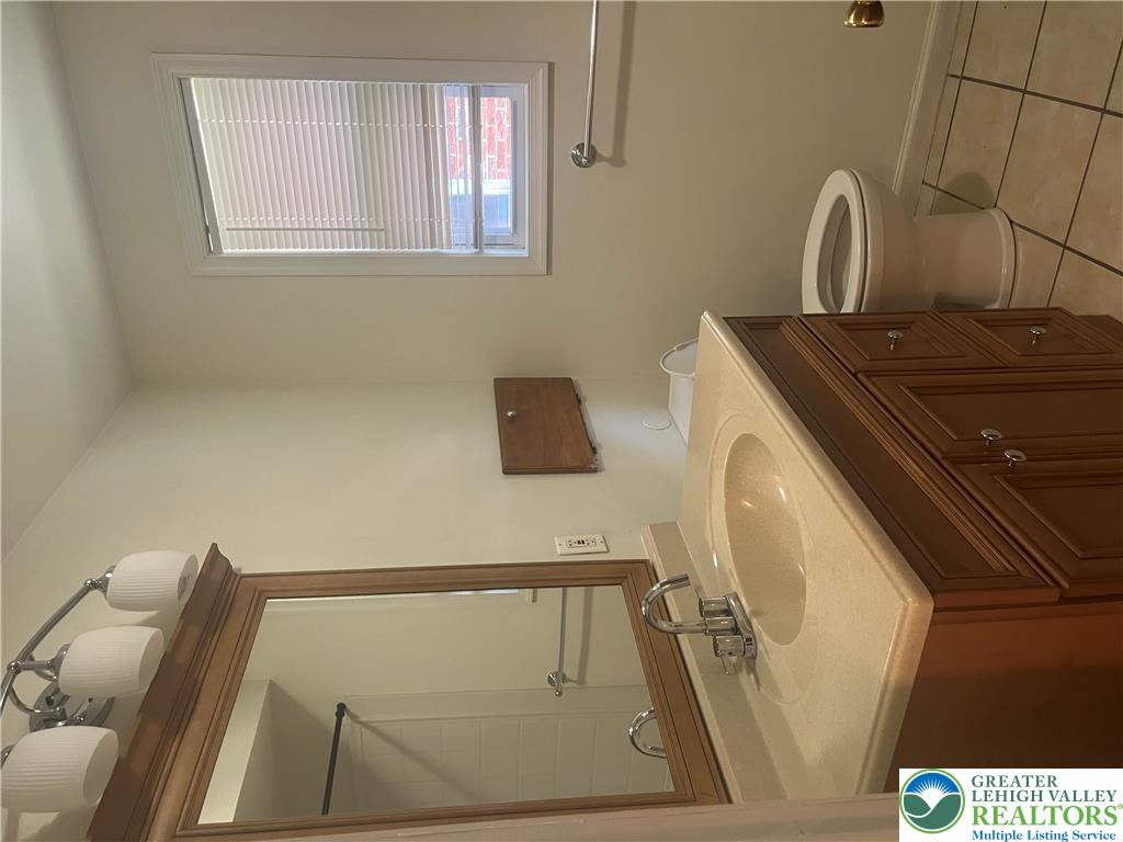 1839 Willow Park Road Bethlehem, PA 18020 - Photo 17 of 35 Well-appointed bathroom features a single vanity, a window, and tile flooring.