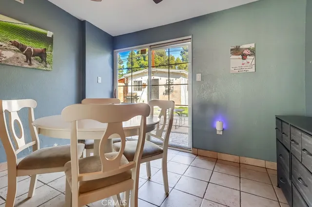 a view of a dining room with furniture and a window