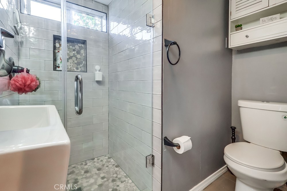 5202 Fidler Avenue Lakewood, CA 90712 - Photo 13 of 30 a bathroom with a toilet sink and shower