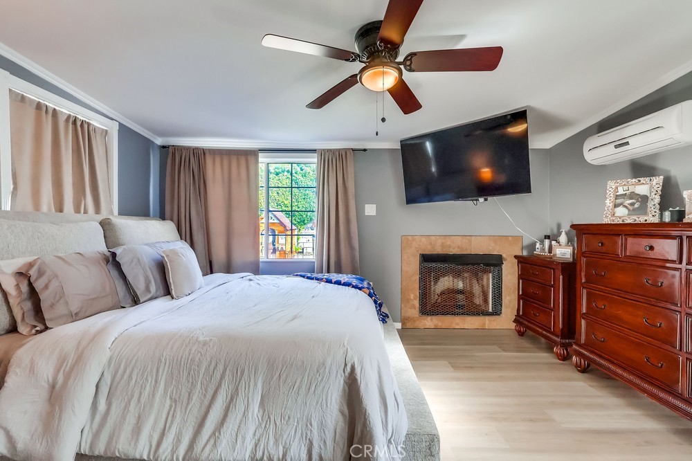 5202 Fidler Avenue Lakewood, CA 90712 - Photo 14 of 30 a spacious bedroom with a bed and a flat screen tv