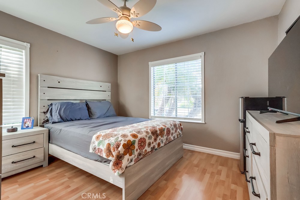 5202 Fidler Avenue Lakewood, CA 90712 - Photo 18 of 30 a bedroom with a bed and a chandelier