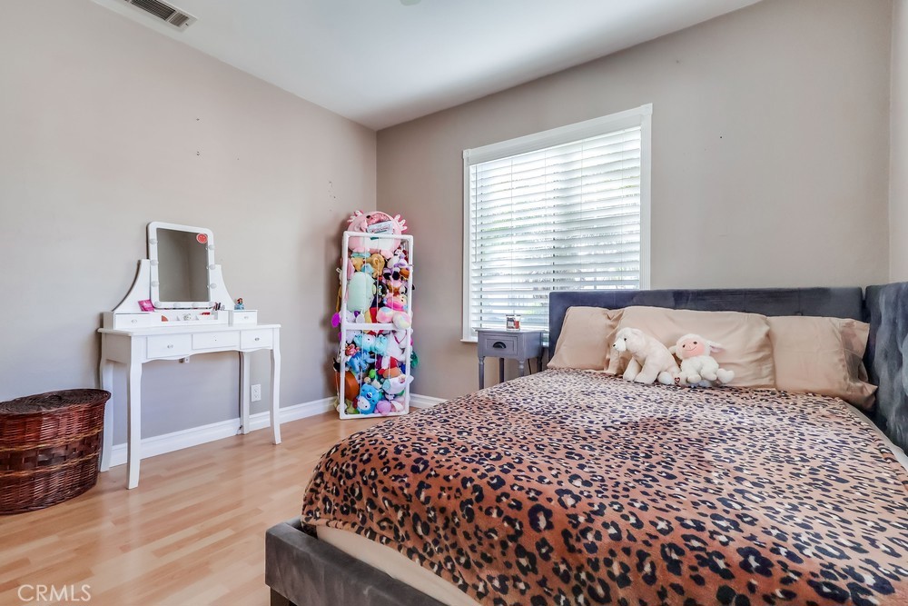 5202 Fidler Avenue Lakewood, CA 90712 - Photo 21 of 30 a bedroom with a bed and a dresser in it