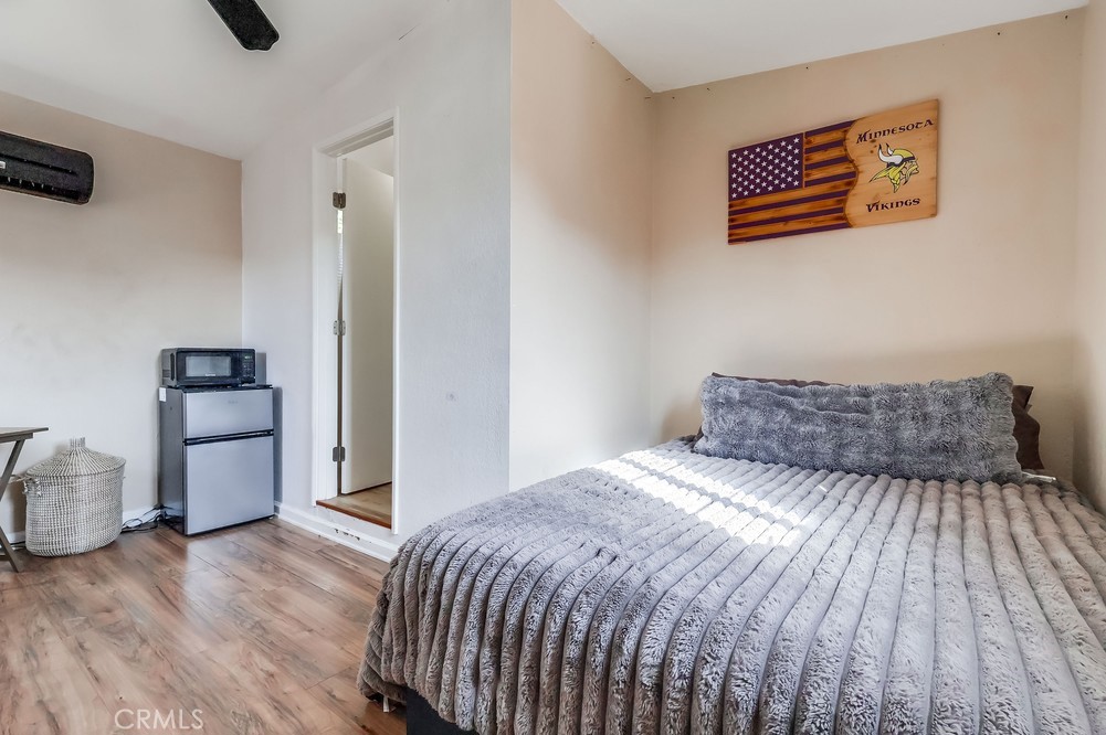 5202 Fidler Avenue Lakewood, CA 90712 - Photo 28 of 30 a bedroom with a bed and wooden floor