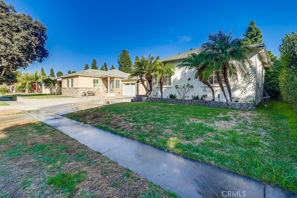 5202 Fidler Avenue Lakewood, CA 90712 - Photo 3 of 30 a view of a house with a yard and potted plants