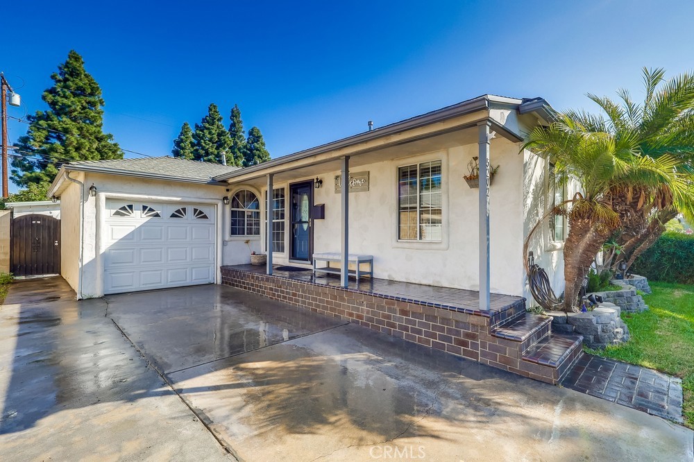 5202 Fidler Avenue Lakewood, CA 90712 - Photo 4 of 30 a view of a house with a small yard and potted plants