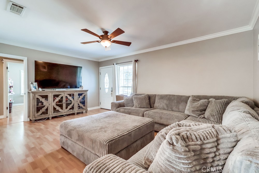5202 Fidler Avenue Lakewood, CA 90712 - Photo 6 of 30 a living room with furniture and a flat screen tv