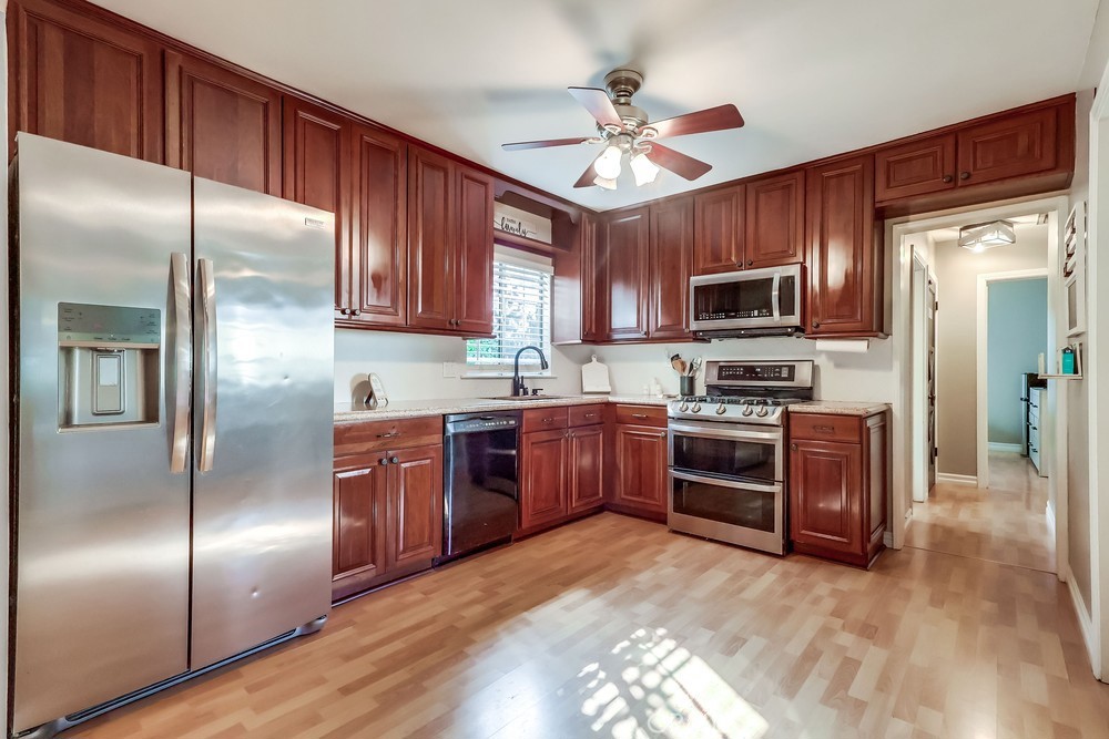 5202 Fidler Avenue Lakewood, CA 90712 - Photo 8 of 30 a kitchen with granite countertop stainless steel appliances cabinets a sink and a center