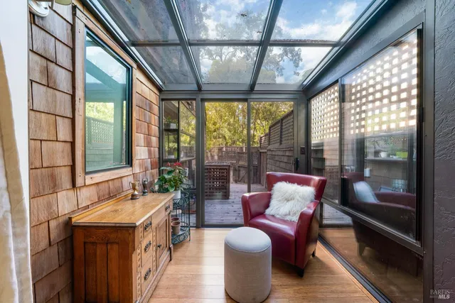 a balcony with furniture and a potted plant