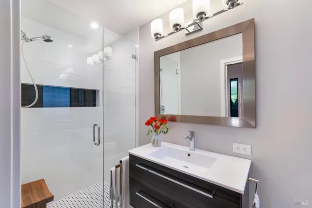 a bathroom with a sink a toilet and mirror