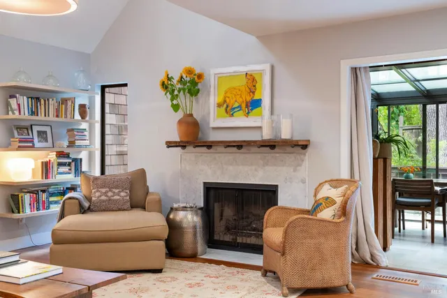 a living room with furniture and a fireplace